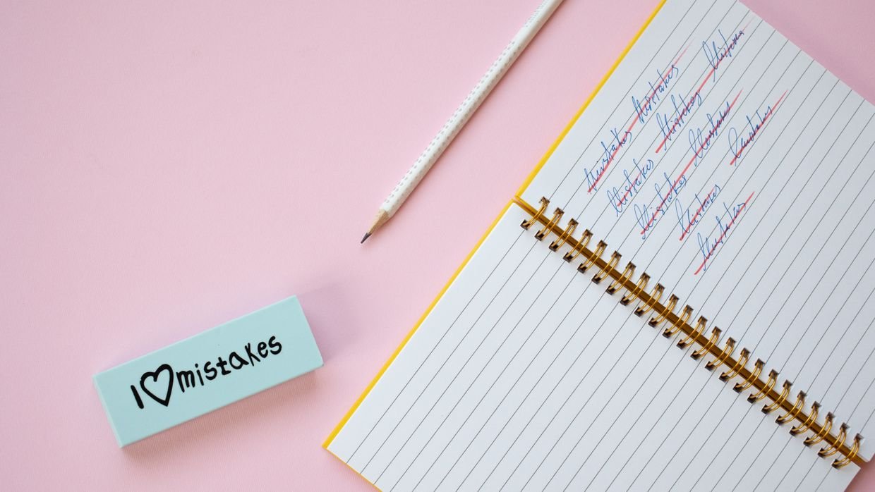An eraser removing pencil writing.