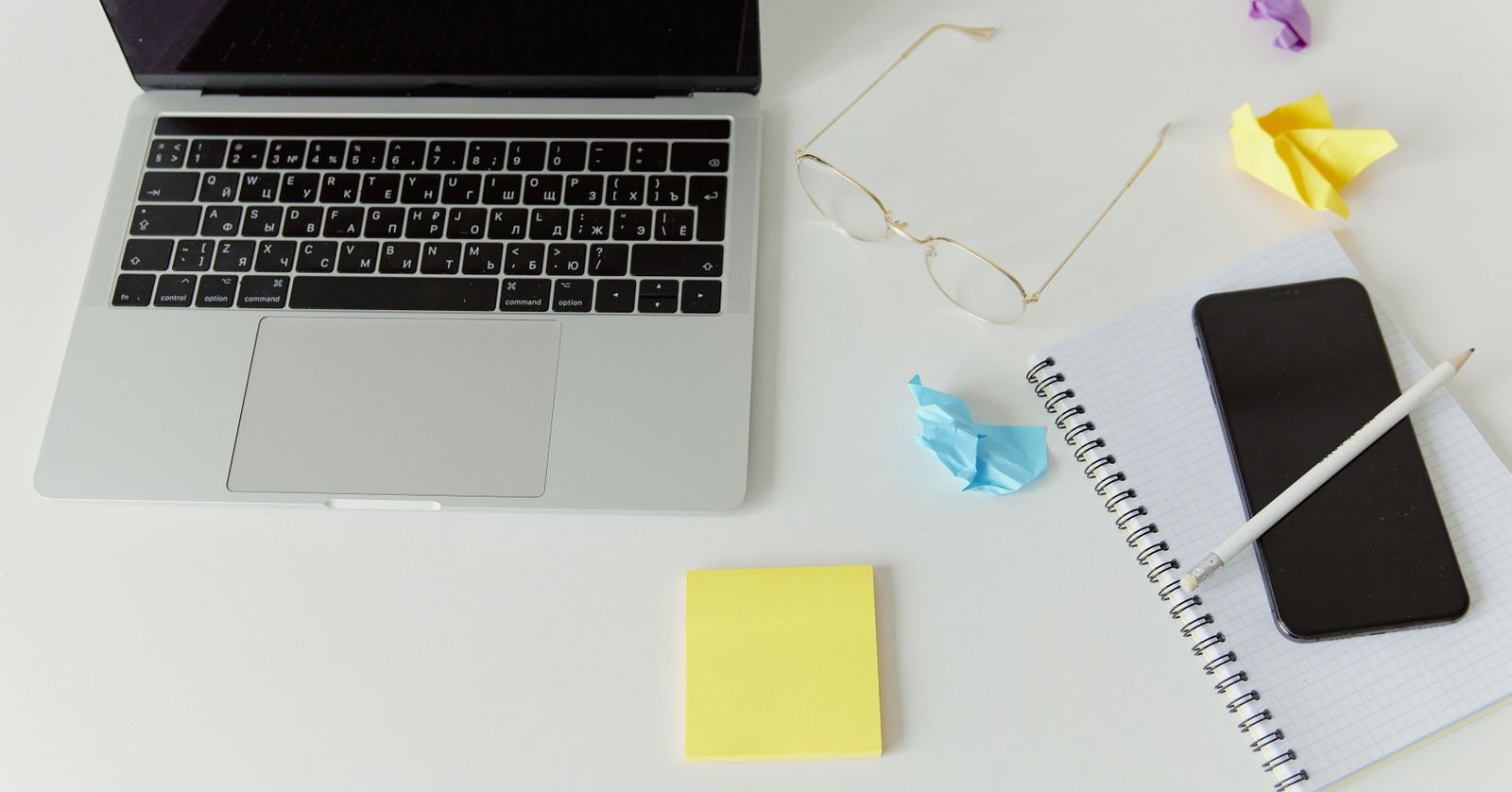 Crumpled paper next to an open notebook.