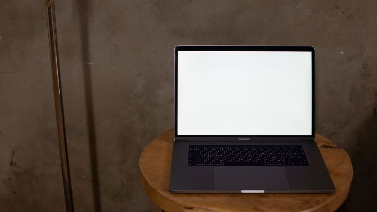 A blank screen on a dark desk.