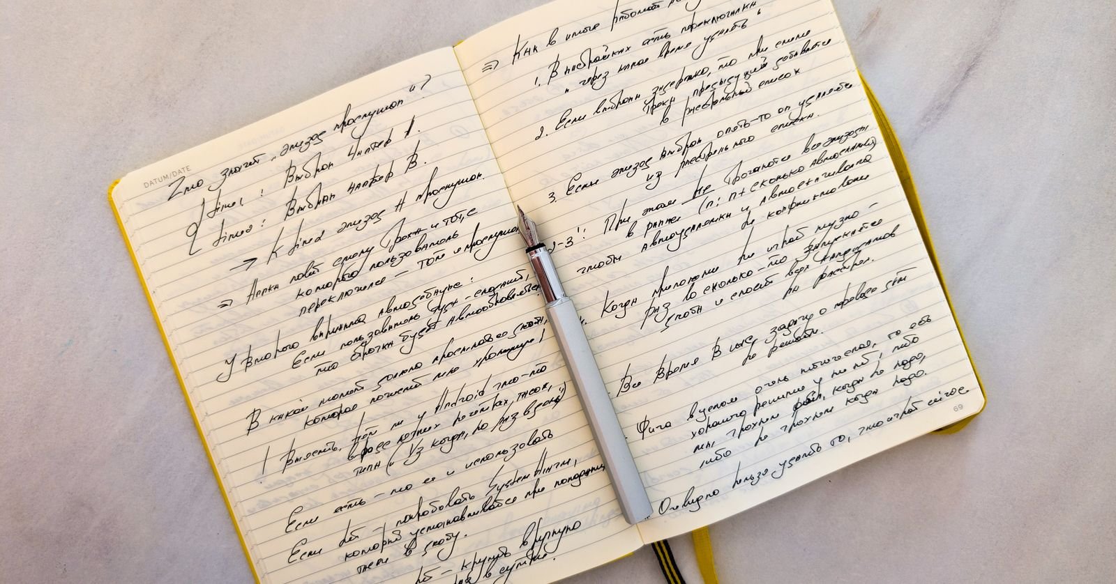 An open notebook of structured notes with a pen.