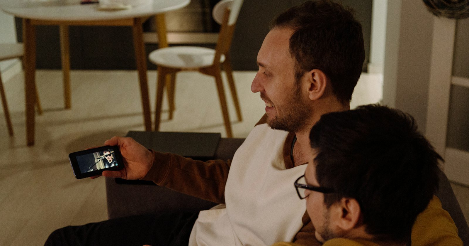 A person watching a video on a phone, where YouTube’s built-in Ask feature would appear.