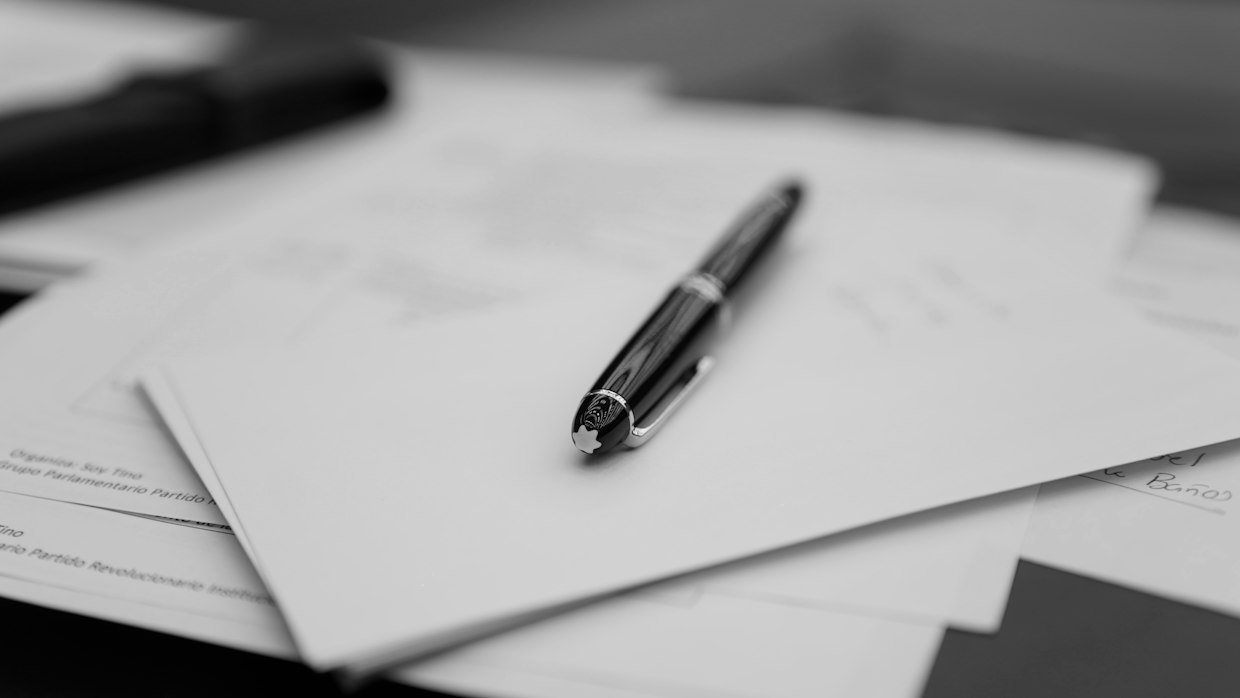 A printed page on a desk, the kind of fixed document a separate summarizer produces.