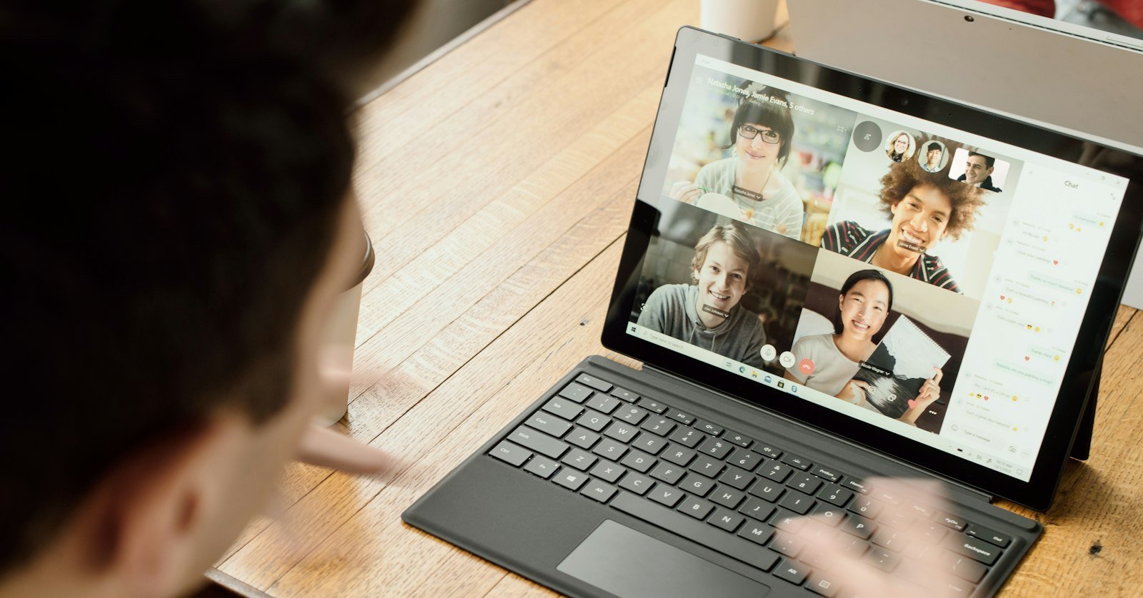 A laptop displaying a grid of video call participants.