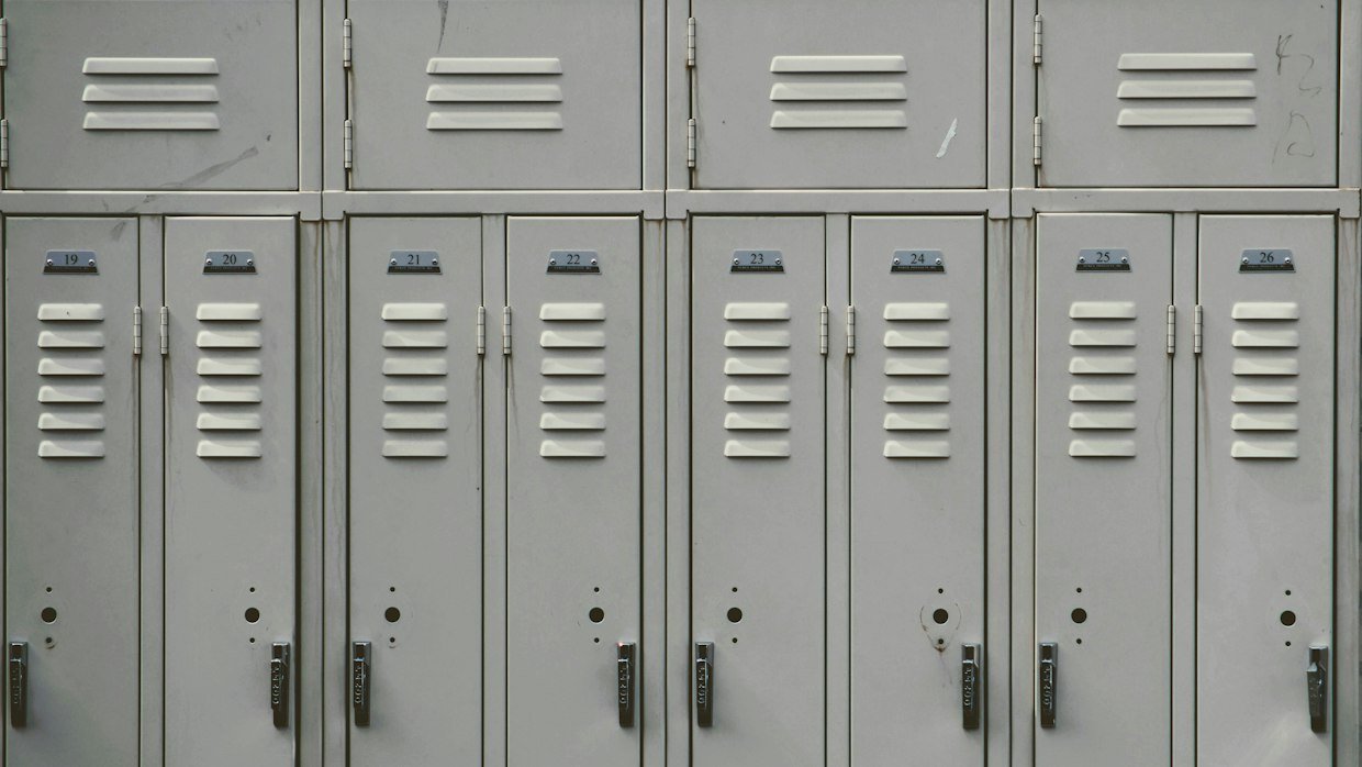 A row of lockers with keys in the doors.