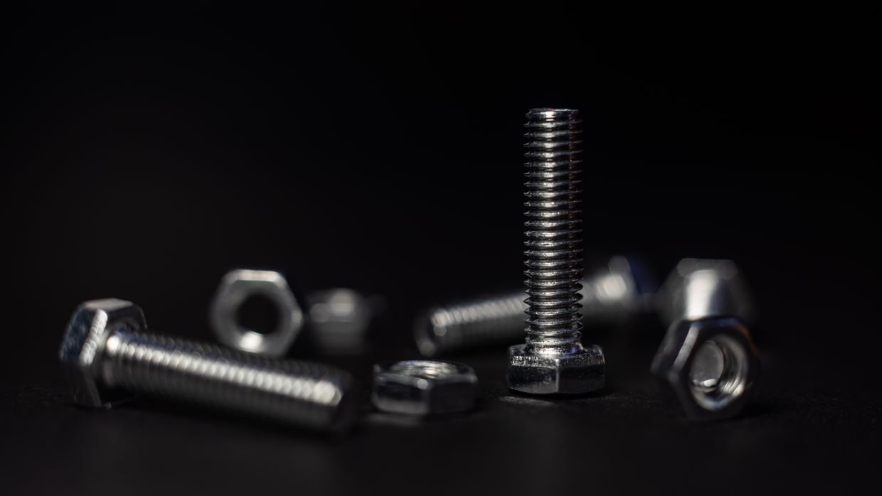 A bolt that does not fit the nut beside it.